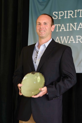 Photo of Dan Ballard looking out toward the audience while receiving his award.