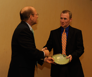 Photo of Award recipient Trey McDonald receives his award from Mike Kensler, Director of the Office of Sustainability at Auburn University.