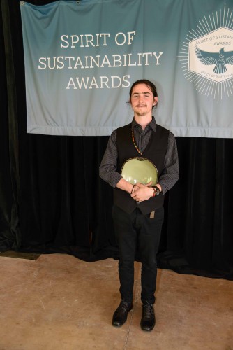 Photo of Sam Price with his Spirit of Sustainability Award bowl.