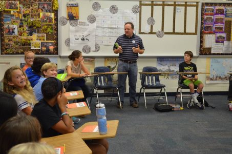 Photo of Dr. Mark Wilson talking with young students.