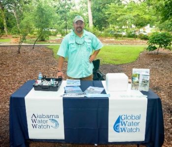 Photo of Michael representing Alabama Water Watch with a table at our 2016 Sustainability Picnic.
