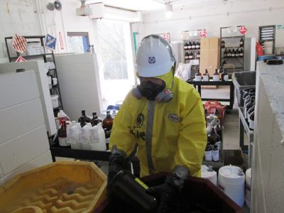 Photo of Michael at work ensuring the proper handling of hazardous materials.