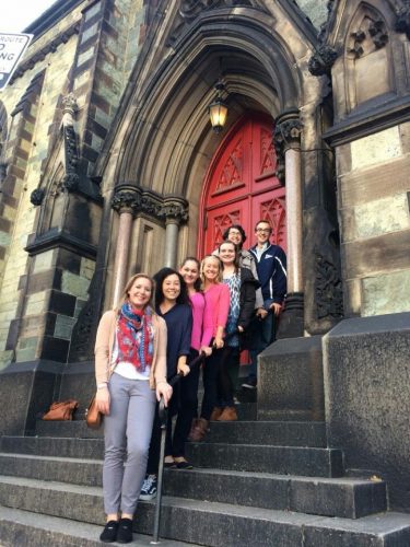 Interns standing on steps of historic building at the sustainability conference