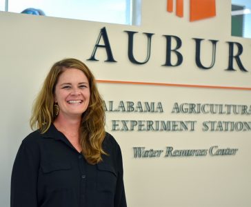 Mona Dominguez poses in front of the Alabama Agriculture Experiment Station