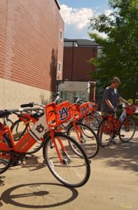 A student checking out a bike from a War Eagle Bike Share hub station.