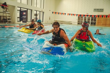 Photo of students in kayaks in a swimming pool