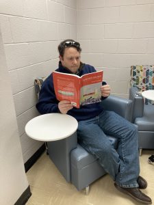 Image of a man reading a book.