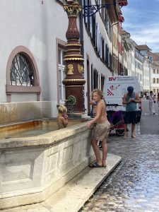 Local children bathe in public fountain