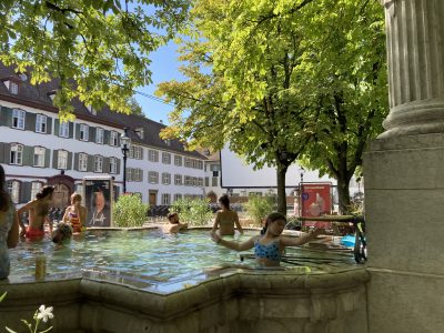Swiss locals swim in public fountain