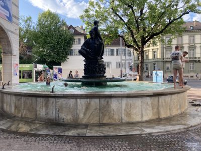 Public fountain with a large statue in the center