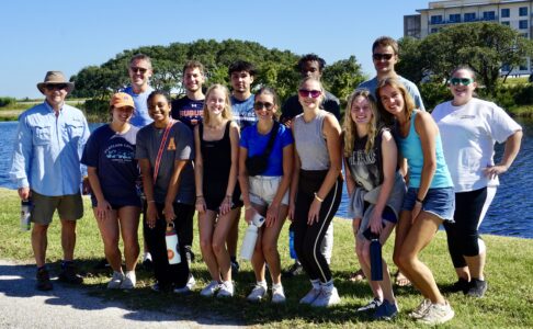 A group of smiling people gathered outdoors.