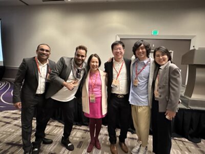 A group of people smiling to the camera. 