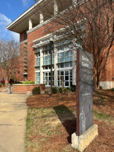 The Gorrie Center, a red-brick building with large windows and a sign in front.