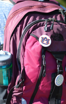 Backpack with reusable water bottle and a recycling button