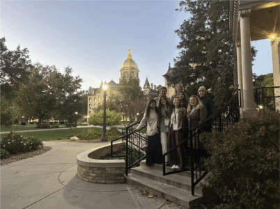 The 8 staff members of the Office of Sustainability in front of the cathedral on Notre Dame's campus