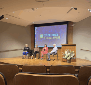 A panelist discussion of 4 speakers in an auditorium