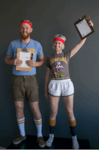 a couple dresses in a retro gym teacher costume with clipboards and whistles.