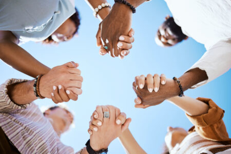 Hand of diverse group in solidarity for united team building collaboration and teamwork success.