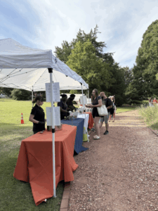 rows of tables with food to serve to a line of people
