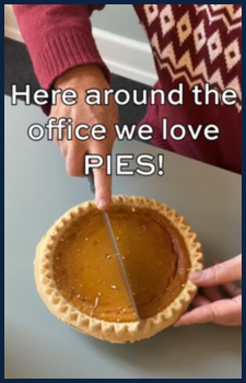 a hand cutting into a pumpkin pie with the text "here around the office we love pies"