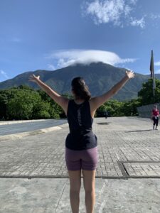 a girl in front of a mountain range