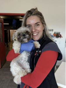a girl holding a shitzu dog