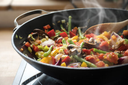 vegetables steaming in a cast iron skillet
