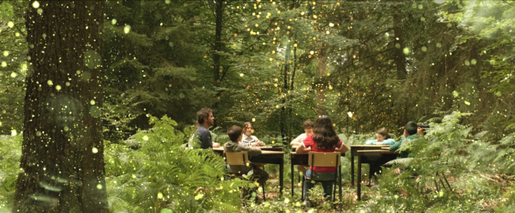 children gathered around a table in the forest