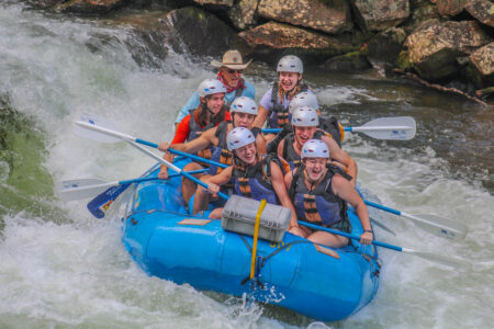 a group of auburn outdoors students white water rafting
