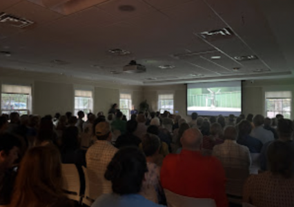 a crowd of people inside watching the alabama rivers alliance films