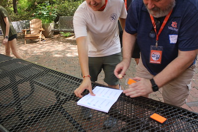 a volunteer and a student at an activity station