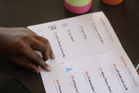 somone filling out their event booklet for the aumazing race