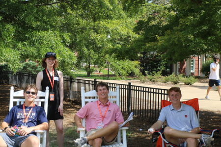 4 students volunteering on cater lawn